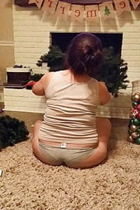 Жена в трусах с целлюлитной задницей украшает елку