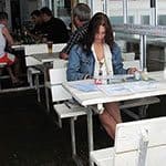 Женщина без трусиков под юбкой обедает в кафе