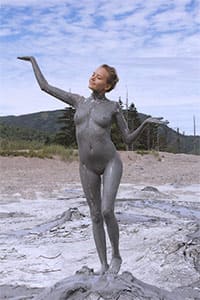 Молодая нудистка в лечебной грязи